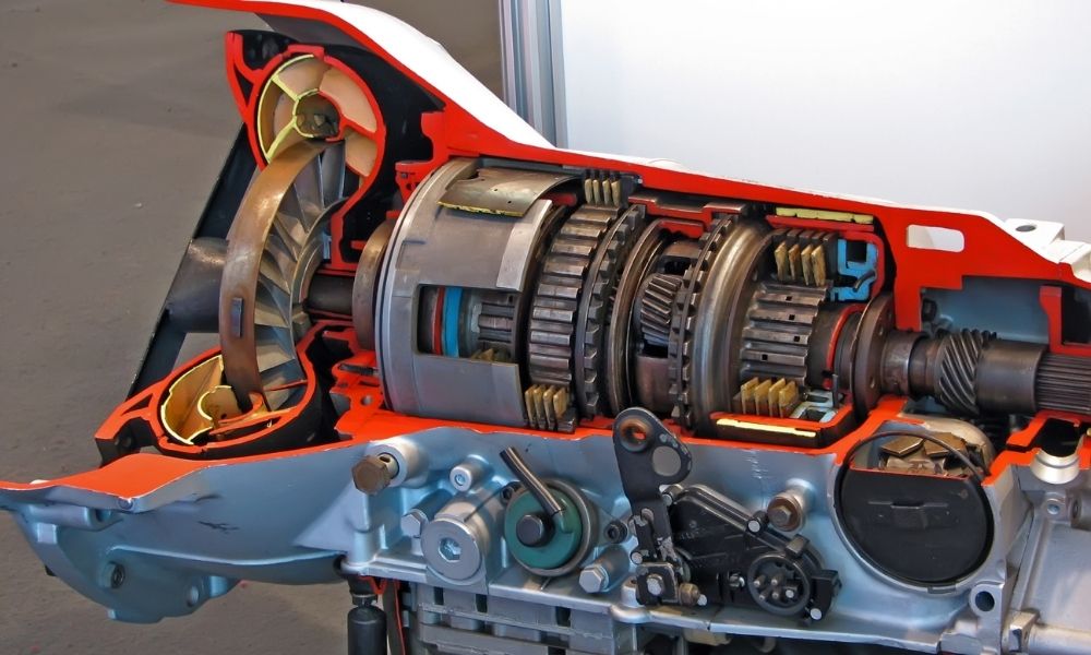 A detailed cross-sectional view of a mechanical transmission system, showing gears, shafts, and internal components inside a partially disassembled machinery.