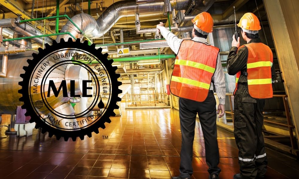 Two industrial workers wearing orange safety vests and hard hats are inspecting equipment in a factory or plant. One worker is pointing towards the machinery while the other is holding a walkie-talkie, possibly communicating. The environment features large pipes and industrial infrastructure, with a logo for "Machine Lubrication Engineers" (MLE) overlayed on the image. Professional Certification
