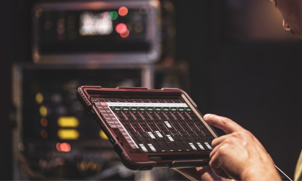 a hand point to a remote-control tablet